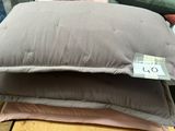 three pillows stacked on top of each other on a table
