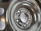 a close up of a metal wheel with holes on it