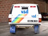 a van with a rainbow painted on the back parked in a parking lot