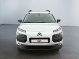 the front of a white citrole parked in a white room