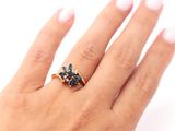 a woman ' s hand with a ring on it