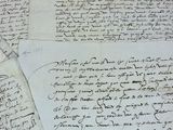 several pieces of old paper with writing on them on a table
