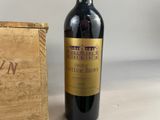 a bottle of wine sitting next to a wooden box