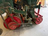a red and green machine that is sitting on the ground