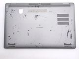 a broken laptop computer sitting on top of a white table
