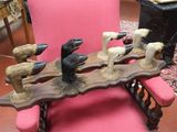 a pink chair that has a bunch of birds on it