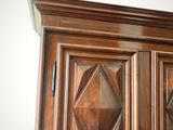 a large wooden cabinet with a mirror on top of it