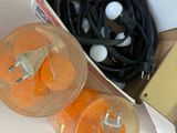 two oranges in a box with wires in it
