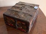 an old wooden box on a table with a tag on it