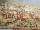 two rugs on the floor with a painting on them