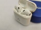 two airpods sitting in a blue case on a white surface