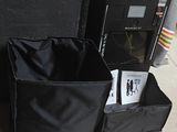 a black box with a magazine inside of it next to a black box with a magazine inside of it