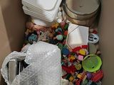 a cardboard box filled with plastic toys and other items