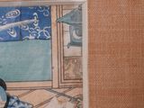 a picture of a woman sitting at a table in a room