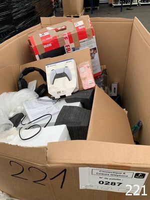 a cardboard box full of electronic equipment in the street