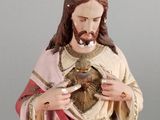statue of jesus holding the sacred heart of jesus in his hands