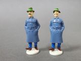 pair of figurines of two men in blue coats and green hats