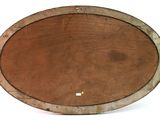 a wooden plate with a hole in it on a white surface