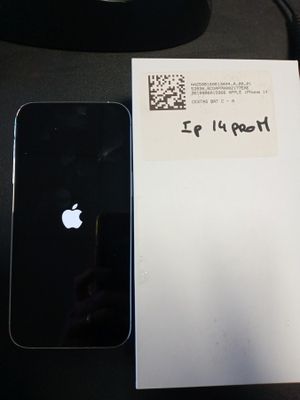 un iPhone noir posé à côté d'une feuille blanche sur un bureau