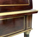 a small desk with a wooden top and gold trimming