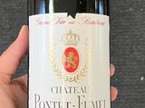 someone holding a bottle of wine with a label on it