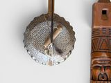 a wooden pole with a wooden carving on it next to other items