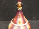 a small figurine of a man with a hat on it