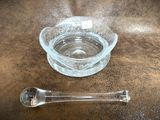 a glass bowl and a spoon on a table