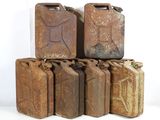 several old rusty gas canisters stacked on top of each other