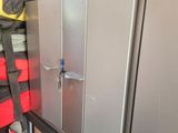 a metal cabinet in the corner of a garage