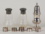several silver and glass salt and pepper shakers and napkins