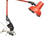 an image of a red desk lamp on a white background