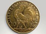 a close up of a gold coin on a white surface