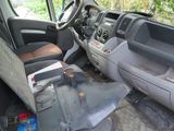 a van that is sitting in the woods with its door open