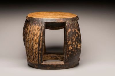 un vieux tabouret en bois surmonté d'une assise en bois