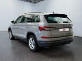 the rear end of a silver volkswagen suv parked in a showroom