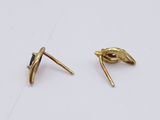 a pair of gold plated earrings with black stones