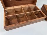 a small wooden box with compartments on a table