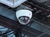 a camera mounted on the ceiling of a building