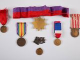 an image of a group of medals and ribbons on a white surface