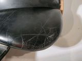 a close up view of a motorcycle seat with a leather cover