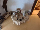 a table with a white table cloth on it in the middle of a room