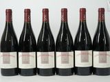 six bottles of red wine are lined up in a row