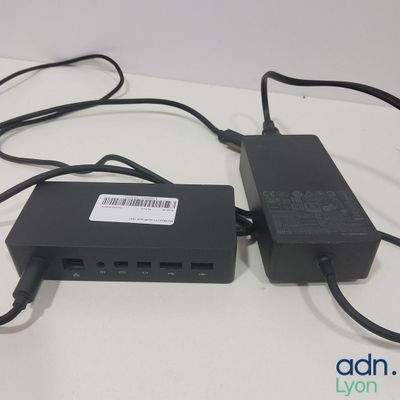 two power cords connected to a charger on a table