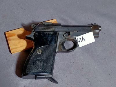 a gun that is laying on the floor with a price tag