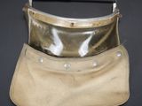 an old leather purse with a metal handle on a black background