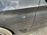 a close up of a car door with a bmw sticker on it