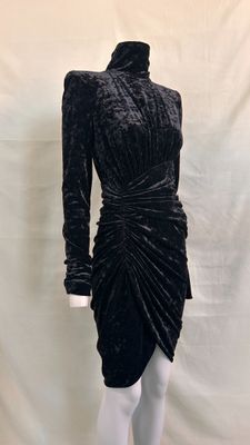 a black velvet dress with long sleeves and a high neckline