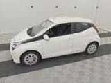 a picture of a small white car parked in a garage