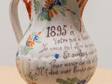 a small vase with a poem on it on a table